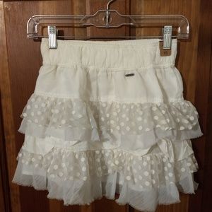 Cream ruffled mini skirt with polka dots
